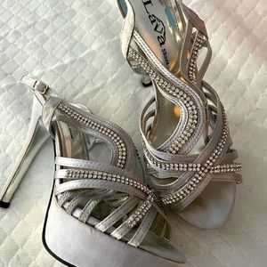Jeweled silver strappy shoes.